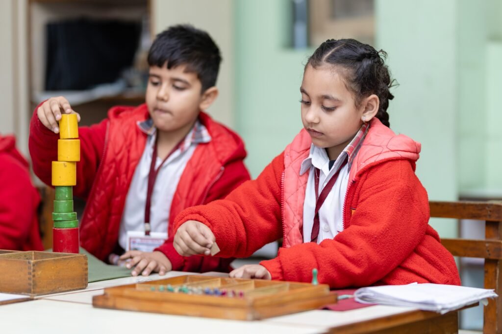 service-3 Two young children focus on educational activities at a classroom table.